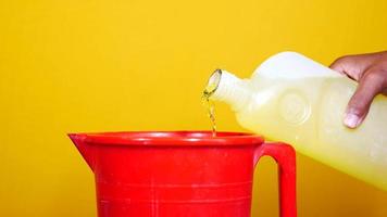 Dilluting cleaning product in a red bucket video