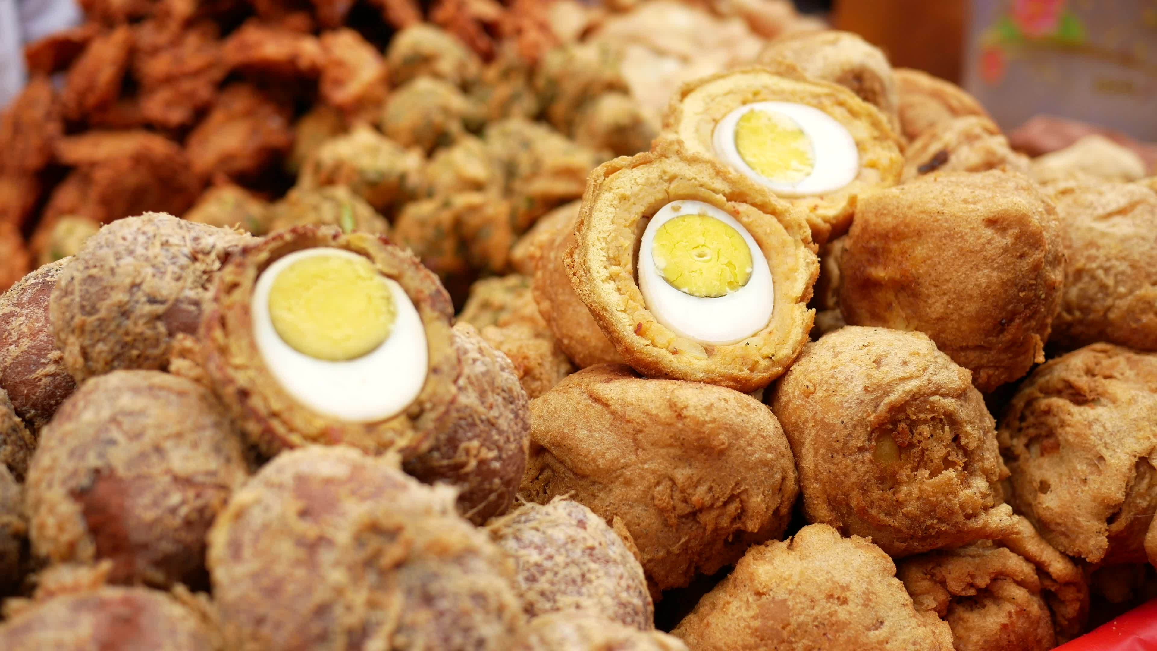Deep fried hard boiled eggs in outdoor market 13748939 Stock Video at