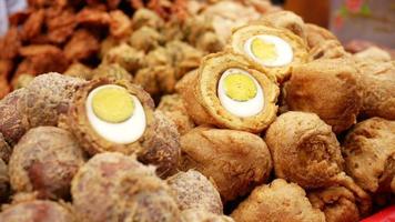 Deep fried hard boiled eggs in outdoor market video