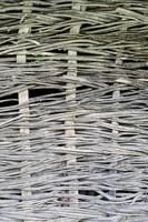 fence made of tree branches boards photo