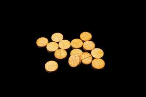 Medical orange pills on isolated on black background photo