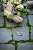 Two wedding rings on the floor with contrast photo