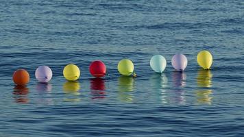 Funny Colorful Balloons Swimming on the Sea Water video