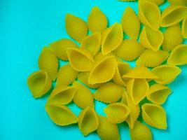 Shell-shaped pasta on the table. Background. Italian food. Cuisine of the peoples of the world. Cooking food. photo