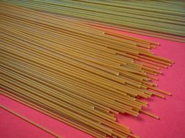 Pasta of two types on the table. Tomato and buckwheat spaghetti. Italian food. Long pasta. Cuisine of the peoples of the world. Cooking food. photo