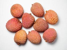 Lychee on the table. Chinese plum on a white background. Ripe fruit from Asia. Delicious  product. photo