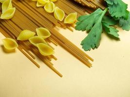 Spaghetti of two types on the table. shells and buckwheat pasta. Italian food. Long pasta. Cooking food. photo