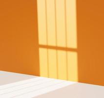 3D empty room for product presentation with window light and bright orange wall photo