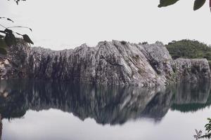 The limestone mountains after the concession explosion during the rainy season form a large and beautiful pond. photo