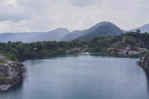 The limestone mountains after the concession explosion during the rainy season form a large and beautiful pond. photo