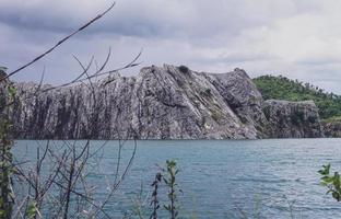 The limestone mountains after the concession explosion during the rainy season form a large and beautiful pond. photo