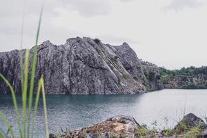 The limestone mountains after the concession explosion during the rainy season form a large and beautiful pond. photo