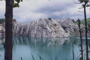 The limestone mountains after the concession explosion during the rainy season form a large and beautiful pond. photo