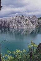 The limestone mountains after the concession explosion during the rainy season form a large and beautiful pond. photo