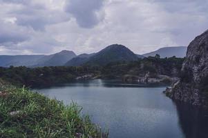 The limestone mountains after the concession explosion during the rainy season form a large and beautiful pond. photo