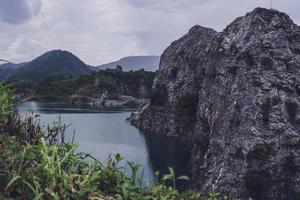 The limestone mountains after the concession explosion during the rainy season form a large and beautiful pond. photo
