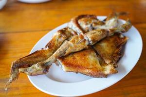 Grilled chicken in white plate on wooden floor - traditional Thai menu  It's a simple and popular dish. photo