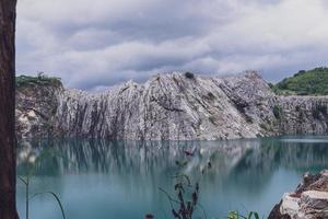 The limestone mountains after the concession explosion during the rainy season form a large and beautiful pond. photo