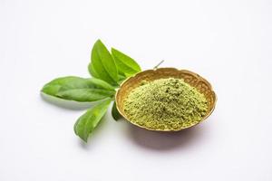 Herbal henna or Mehandi powder in a bowl forming heap, Used for Tattoo or Hair Dye in India photo