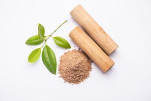 Chandan or sandalwood powder with sticks, perfume or oil which retain their fragrance for decades photo