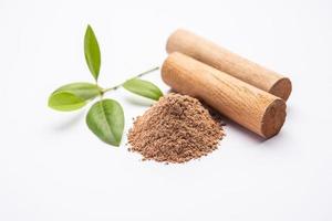 Chandan or sandalwood powder with sticks, perfume or oil which retain their fragrance for decades photo