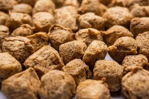 Glycine max or Soya bean or uncooked soybean chunks. Served in a bowl or as a Pile. selective focus photo