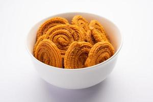 Chakli is a savoury snack from India. It is a spiral shaped snack with a spiked surface photo