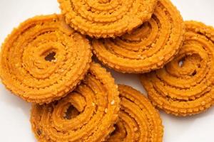 Chakli is a savoury snack from India. It is a spiral shaped snack with a spiked surface photo