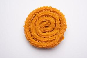 Chakli is a savoury snack from India. It is a spiral shaped snack with a spiked surface photo