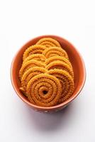 Chakli is a savoury snack from India. It is a spiral shaped snack with a spiked surface