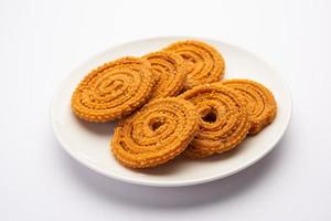 Chakli is a savoury snack from India. It is a spiral shaped snack with a spiked surface photo