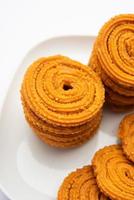 Chakli is a savoury snack from India. It is a spiral shaped snack with a spiked surface photo