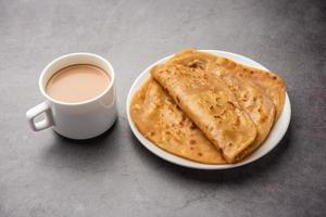 Chai Paratha - Hot Tea served with Flatbread is a traditional simple meal from India and Pakistan photo