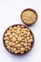 Glycine max or Soya bean or uncooked soybean chunks. Served in a bowl or as a Pile. selective focus photo