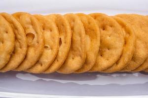 Mathri or mathari is a Rajasthani, Indian snack and a type of flaky biscuit, tea time snack photo