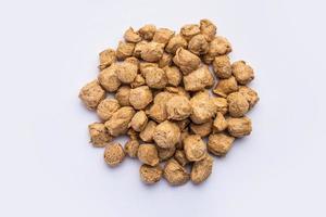 Glycine max or Soya bean or uncooked soybean chunks. Served in a bowl or as a Pile. selective focus photo