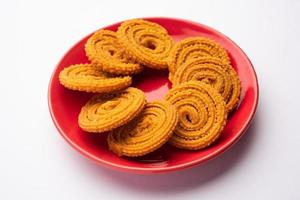 Chakli is a savoury snack from India. It is a spiral shaped snack with a spiked surface photo