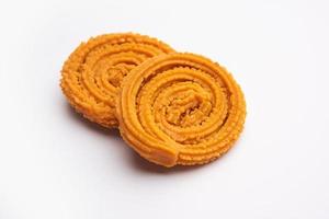 Chakli is a savoury snack from India. It is a spiral shaped snack with a spiked surface photo