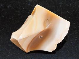 rough brown Flint stone on dark background photo