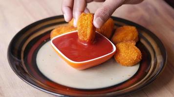 Dipping chicken nugget in catchup video