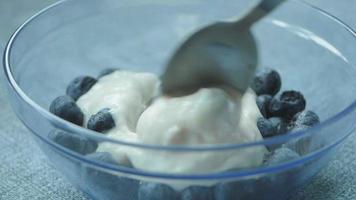 Spoon in yogurt with blueberries video