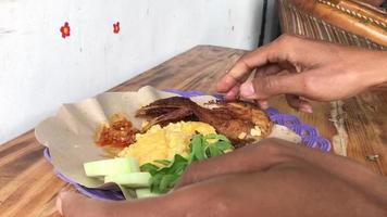 plate of fried chicken and rice on a wooden table video
