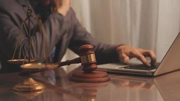 Business and lawyers discussing contract papers with brass scale on desk in office. Law, legal services, advice, justice and law concept video