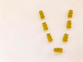 creative edible letter V made from gummy bears. Letter made from yellow gelatinous candies. homemade sweets. cooking masterpiece. sweets, delicious dessert photo