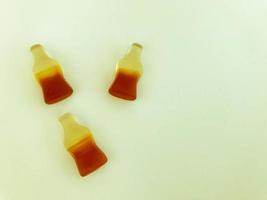 the letter V made from marmalade in the form of bottles with lemonade. creative letter. gummy words. unusual inscription. delicious and sweet letter. word from food. edible alphabet photo