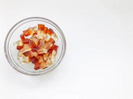 fruit gelatinous sweets. the bottle-shaped marmalade is in a small, round and transparent plate. making homemade sweets. baby treat, unusual shape of sweets photo