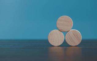 Stacking blank wooden cubes on blue background with copy space for input wording and infographic icon. Empty brown wooden object block for symbol icon put technology, zero gravity, business concept. photo