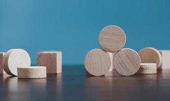 Stacking blank wooden cubes on blue background with copy space for input wording and infographic icon. Empty brown wooden object block for symbol icon put technology, zero gravity, business concept. photo