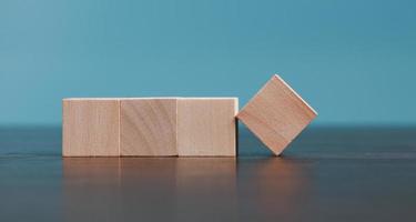 Stacking blank wooden cubes on blue background with copy space for input wording and infographic icon. Empty brown wooden object block for symbol icon put technology, zero gravity, business concept. photo