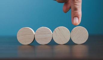 Stacking blank wooden cubes on blue background with copy space for input wording and infographic icon. Empty brown wooden object block for symbol icon put technology, zero gravity, business concept. photo